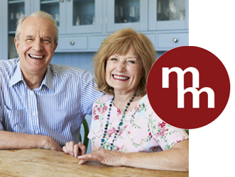 Image of smiling senior adult couple in their kitchen